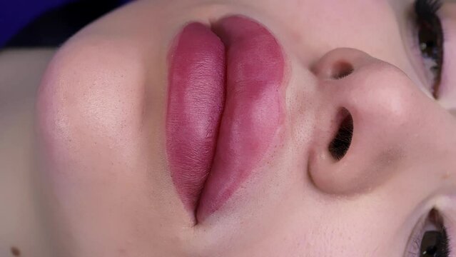 Swollen lips after permanent makeup, master tints with corrective cream. High quality 4k footage