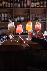 cocktails in a cafe on a wooden table, colorful summer cocktails with ice