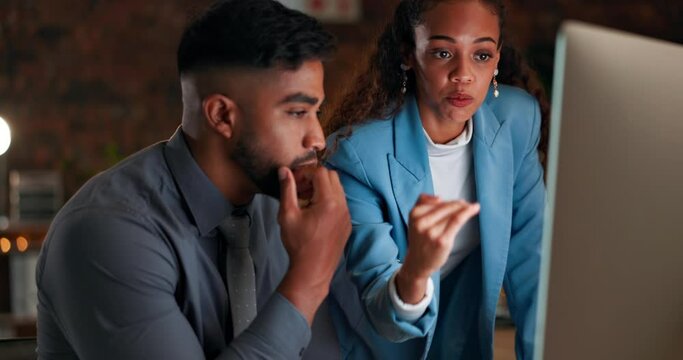 Man, woman and night in office with coaching, learning and pointing at computer for programming together. Teamwork, business people and coach with advice, tips and training with pc in dark workplace