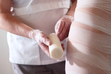 Body wrapping. Fat-burning body wraps. Anti-cellulite wrapping and bandaging procedure.The concept...