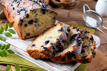 Bread, sliced cake with blueberries. Morning breakfast on wooden table