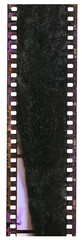 long empty 35mm film strip or material on white with developing smear marks and lime stain. poster...