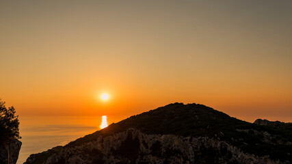 Fototapeta na wymiar Amazing sunset seen from Angelokastro hill, Corfu, Greece