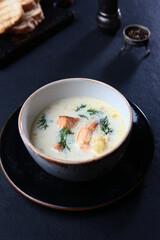 Shrimp and redfish in a traditional French soup.Soup with seafood and cream. Vertical photo.