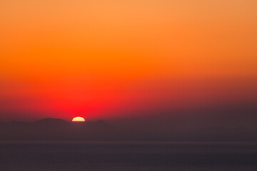 Santorini, Grece - July 23, 2020 -  Amazing red sunset over Oia and caldera of the Santorini island, Greece
