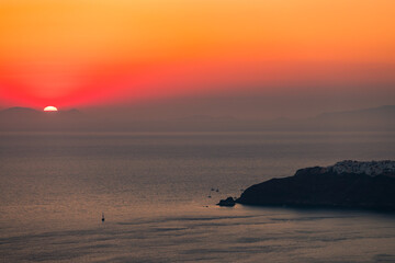 Santorini, Grece - July 23, 2020 -  Amazing red sunset over Oia and caldera of the Santorini island, Greece