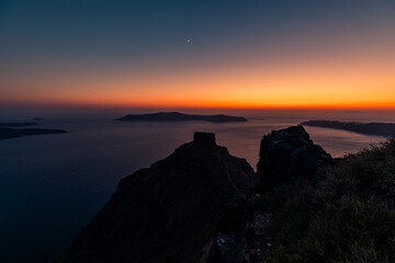 Santorini, Grece - July 23, 2020 -  Amazing red sunset over Oia and caldera of the Santorini island, Greece