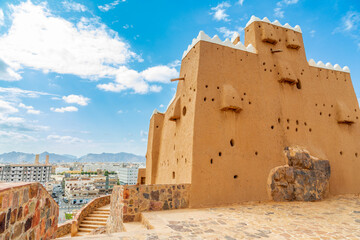 Hail city downtown and walls of Arabian Aarif fortress standing on the hill, Hail, Saudi Arabia - obrazy, fototapety, plakaty
