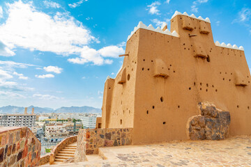 Hail city downtown and walls of Arabian Aarif fortress standing on the hill, Hail, Saudi Arabia