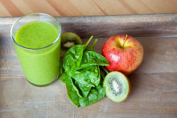 Green health smoothie made from spinach, apples, kiwi. Raw, vegan, vegetarian, detox, alkaline food concept. High quality photo