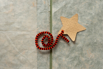 paper star and decorative pipe cleaner on tissue paper