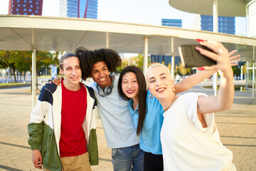 Happy centennial people taking smiling selfie. Group of students together at campus university . High quality photo