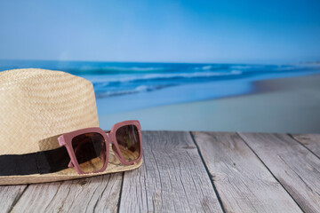 Hats and glasses on the beach, vacation concept 