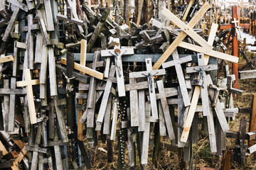 Wooden cross symbol of christianity texture. Holy place catholic religion. Hanging rosary background. Pilgrimage destination. Cementary landscape. Graveyard symbol. Hope background.