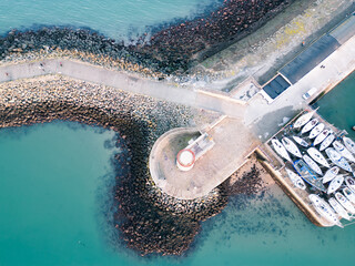 captures the stunning beauty of an Irish lighthouse and the rugged coastline from a unique perspective.