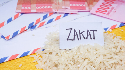 Zakat Islamic Concept. “ZAKAT” wordings wih One hundred thousand rupiah banknote on yellow...
