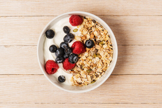 bowl of muesli with berries and yogurt