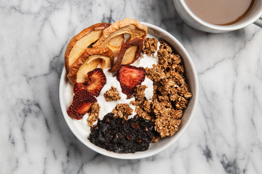Bowl of granola with yogurt and dried fruit