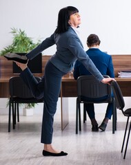 Two employees doing sport exercises in the office