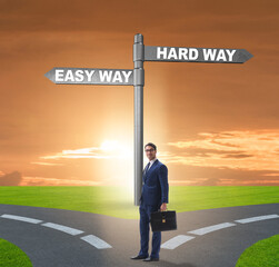 Businessman choosing between hard and easy way