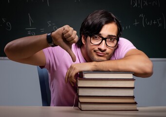 Young male student sitting in classroom