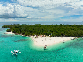 Sandy beach on a tropical island with palm trees. Virgin Island, Philippines.