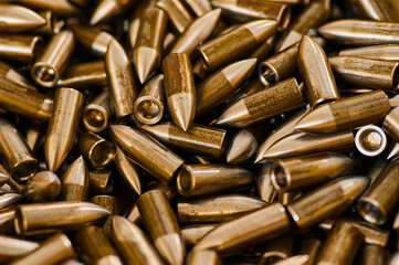 Scattered grey bullets armour ammunition as background