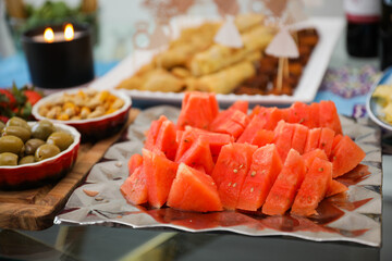 elegantly arranged charcuterie board displaying various meats, cheeses, fruits, and nuts. It symbolizes the joy of abundance and shared experiences, emphasizing the importance of enjoying life
