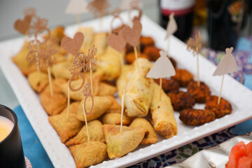 elegantly arranged charcuterie board displaying various meats, cheeses, fruits, and nuts. It symbolizes the joy of abundance and shared experiences, emphasizing the importance of enjoying life