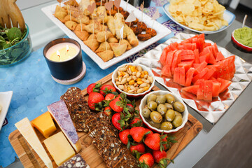 elegantly arranged charcuterie board displaying various meats, cheeses, fruits, and nuts. It symbolizes the joy of abundance and shared experiences, emphasizing the importance of enjoying life
