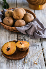 sawo or sapodilla fruit in basket on the wooden table
