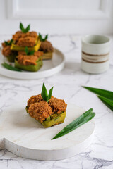 apem or steamed brown sugar aponge cake wrapped in pandanus leaves