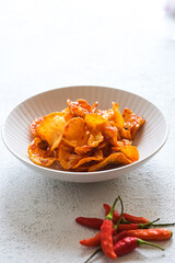 kentang balado, spicy potatoes in white bowl
