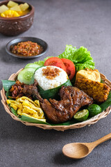 nasi uduk pecal ayam or coconut milk rice pecal chicken, traditional Indonesian food