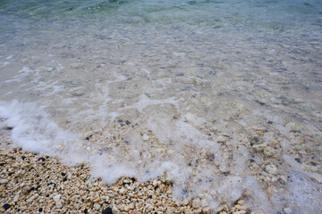 Sandy beach and natural blue ocean wave. Seaside wave closed up view.