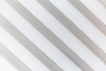 Obraz premium White slatted plastic wall panel. Modern trends in interior design. Space for text.