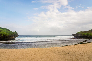 Yogyakarta, Indonesia March 2017 : The southern sea of Java is seen between two coral hills on Sarangan beach.