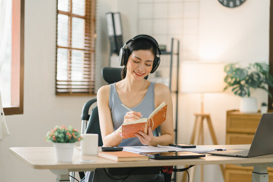 A millennial businesswoman of a startup working with financial report paperwork in her home office. The concept of financial advising teamwork and accounting is depicted.