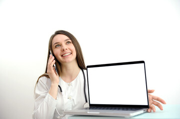 A female doctor working at the desk and pointing up isolated on white background. High quality photo