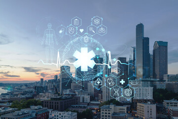 Obraz na płótnie Canvas Seattle aerial skyline panorama of downtown skyscrapers at sunset, Washington USA. Health care digital medicine hologram. The concept of treatment and disease prevention