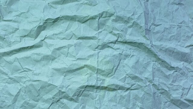 Stop motion photography animation concept. Close-up of crumpled paper of blue color. Textured abstract background with copy space.
