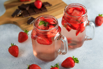 Fototapeta na wymiar Strawberry drink with berries and board with chocolate. Diet drink concept