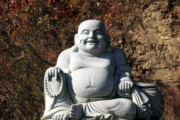 Stone Sculpture of a Laughing Monk