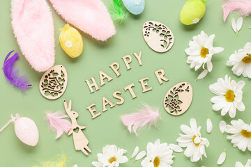 Easter background with  white chrysanthemums flowers, colored eggs and decorations on color background with text 