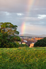 Rainbow at dawn over the city of Gijon on a beautiful rainy day, Asturias.