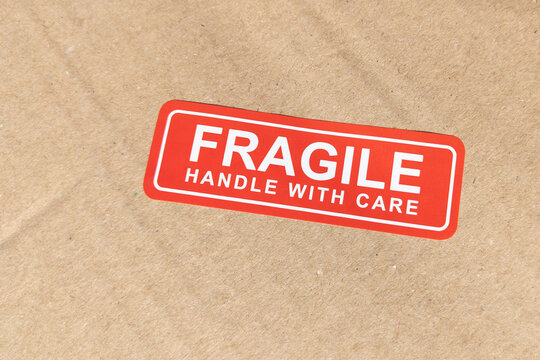 Fragile handle with care sticker on brown carton package