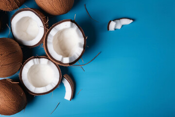 Obraz na płótnie Canvas Coconuts on a blue background with a place for text AI generation