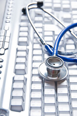 stethoscope and computer keyboard, online doctor concept