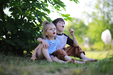 Children walk in the summer in nature. Child on a sunny spring morning in the park. Traveling with children.