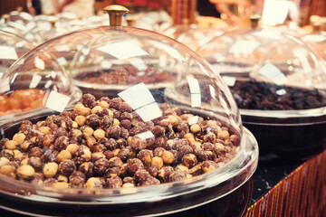 Hazelnut kernels and other nuts on a store counter. 